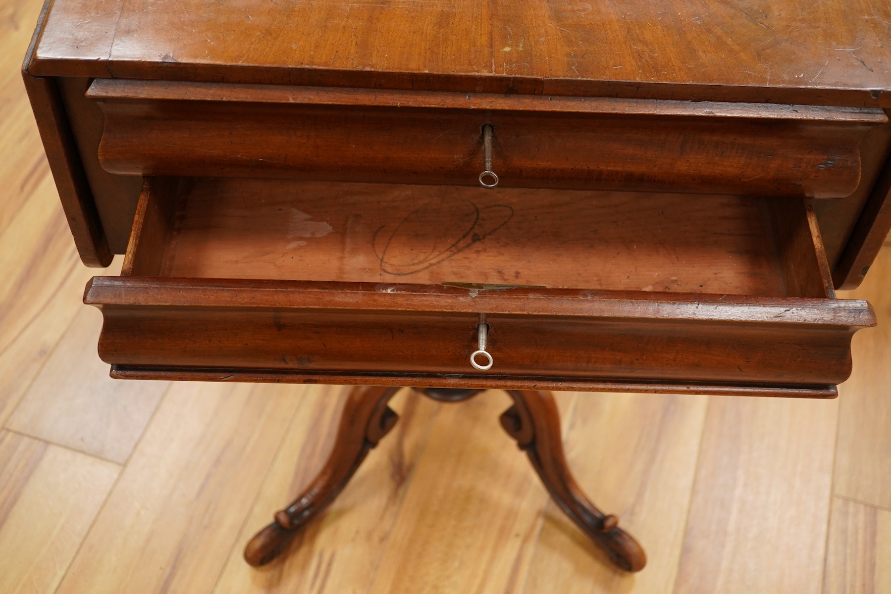 A mid 19th century mahogany pedestal Pembroke table, with inset brass plaque engraved; ‘Presented to Qtr. Master Sgt. Ed. Rainey by his Comrades the Officers, Non-Commissioned Officers and Privates of the 7th Company Lin